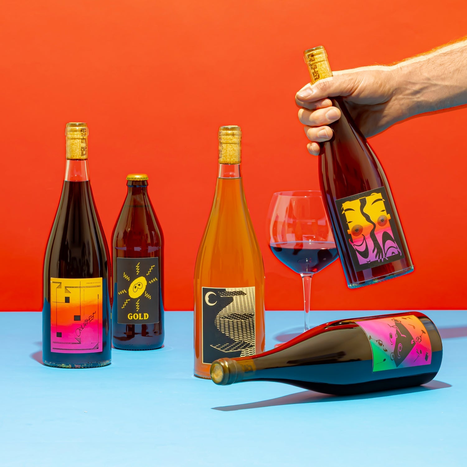 Editorial image of Crusher wines on a bright orange and blue backdrop.