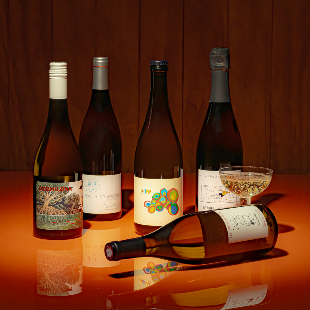 Editorial shoot of five Chenin Blanc from around the world on a orange table.