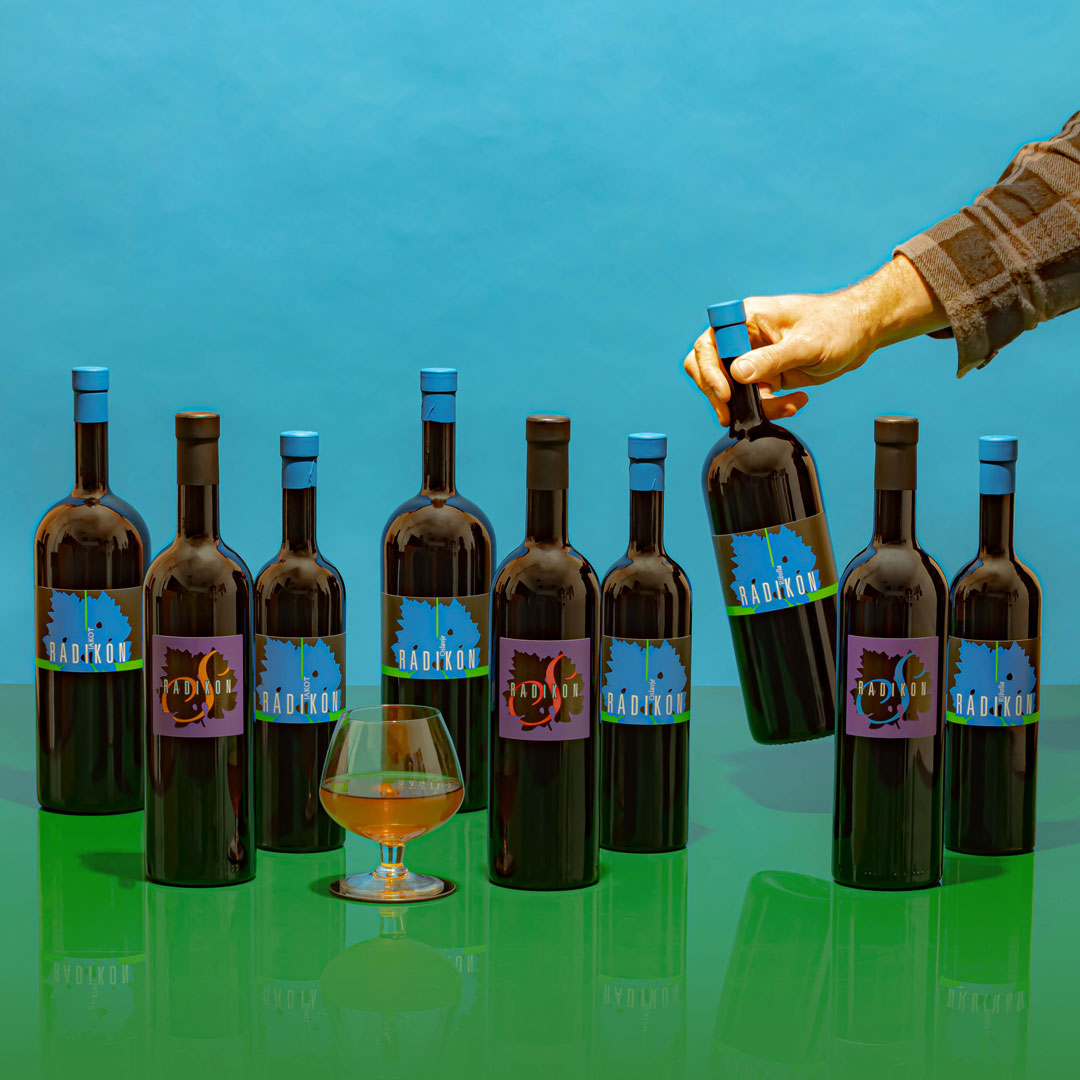 A lineup of the latest Radikon wines on a vibrant orange & blue background.